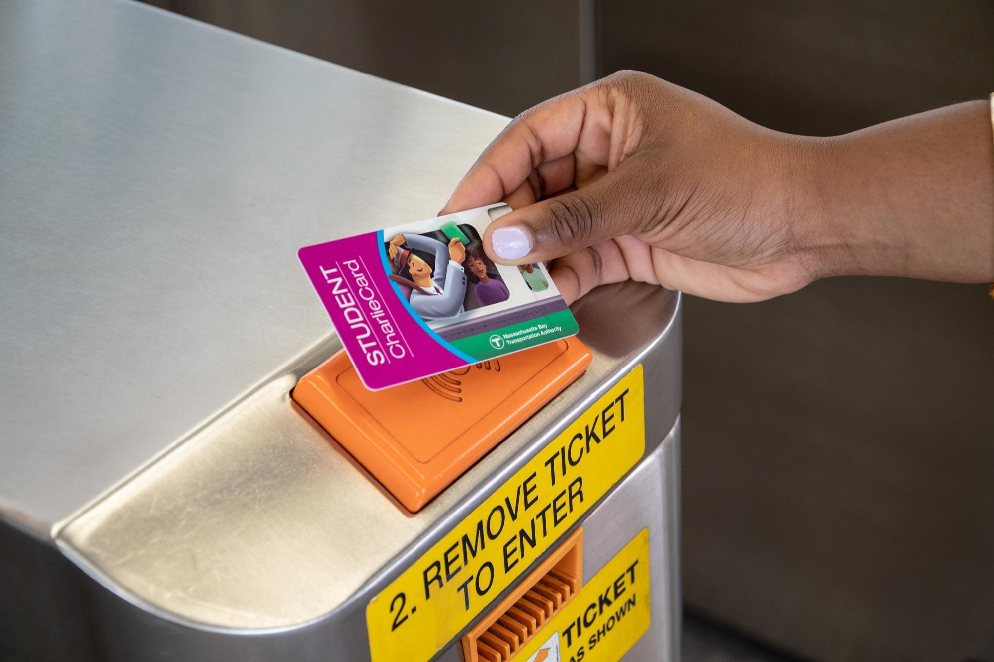 Tapping a purple M7 Student CharlieCard on a subway fare gate