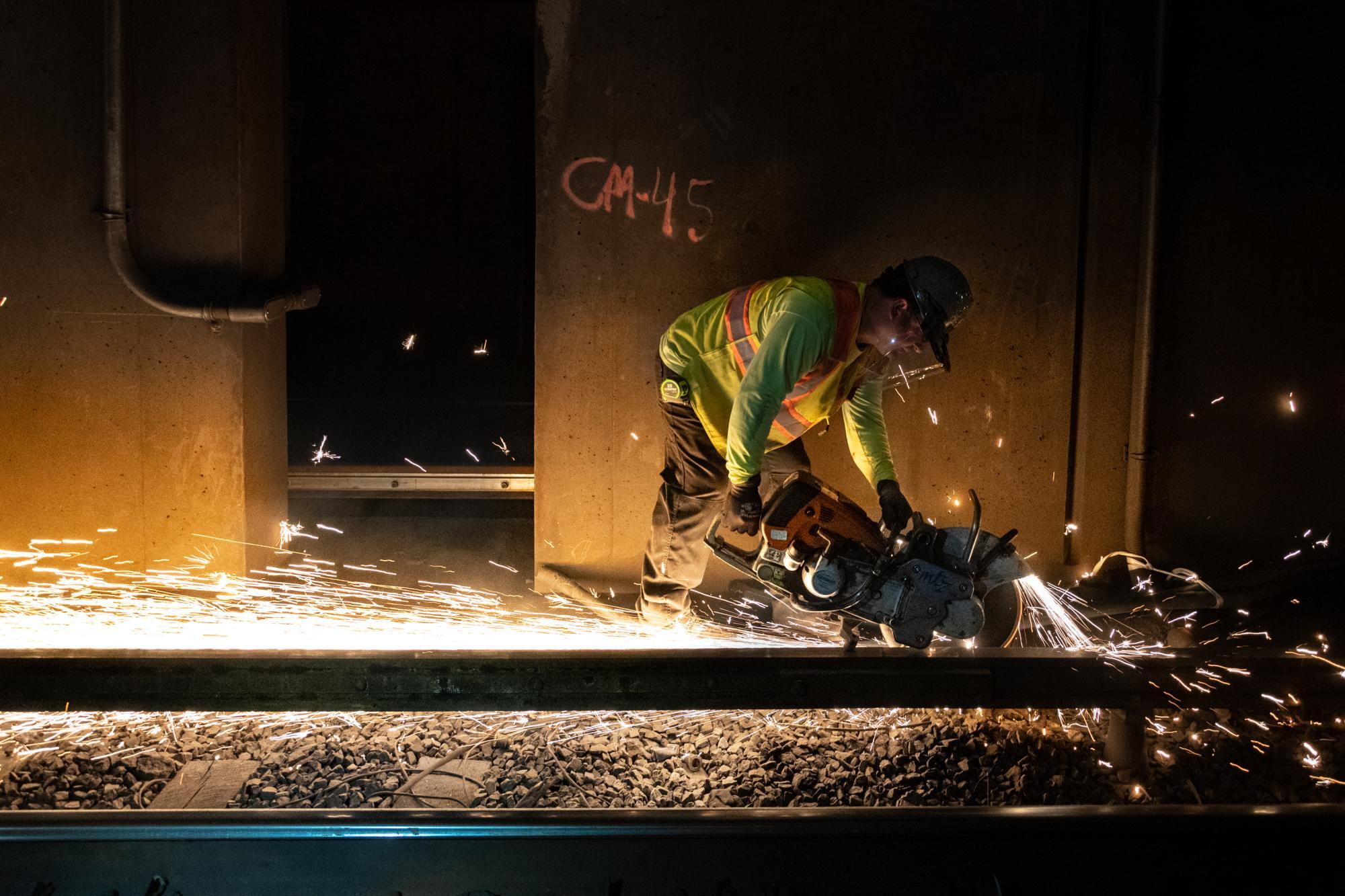 A crew member welds rail on North Station's southbound side during the February 7 – 9, 2020, Orange Line weekend shutdown