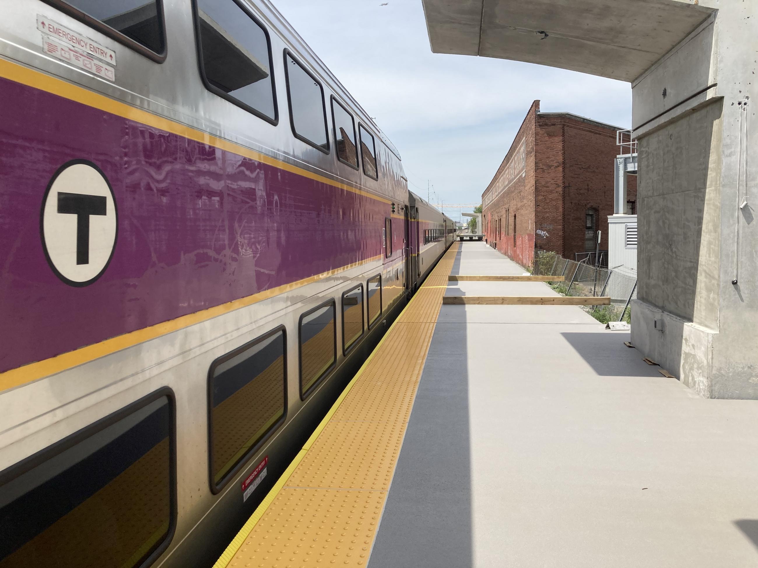 A Commuter Rail train is stopped at the inbound platform at Chelsea Station next to a newly installed platform.
