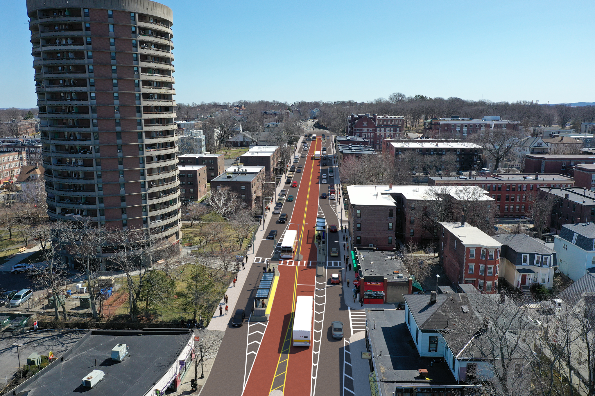 Aerial view of red bus lanes running down the center of Columbus Avenue in Boston. Clear sky and normal traffic conditions. 