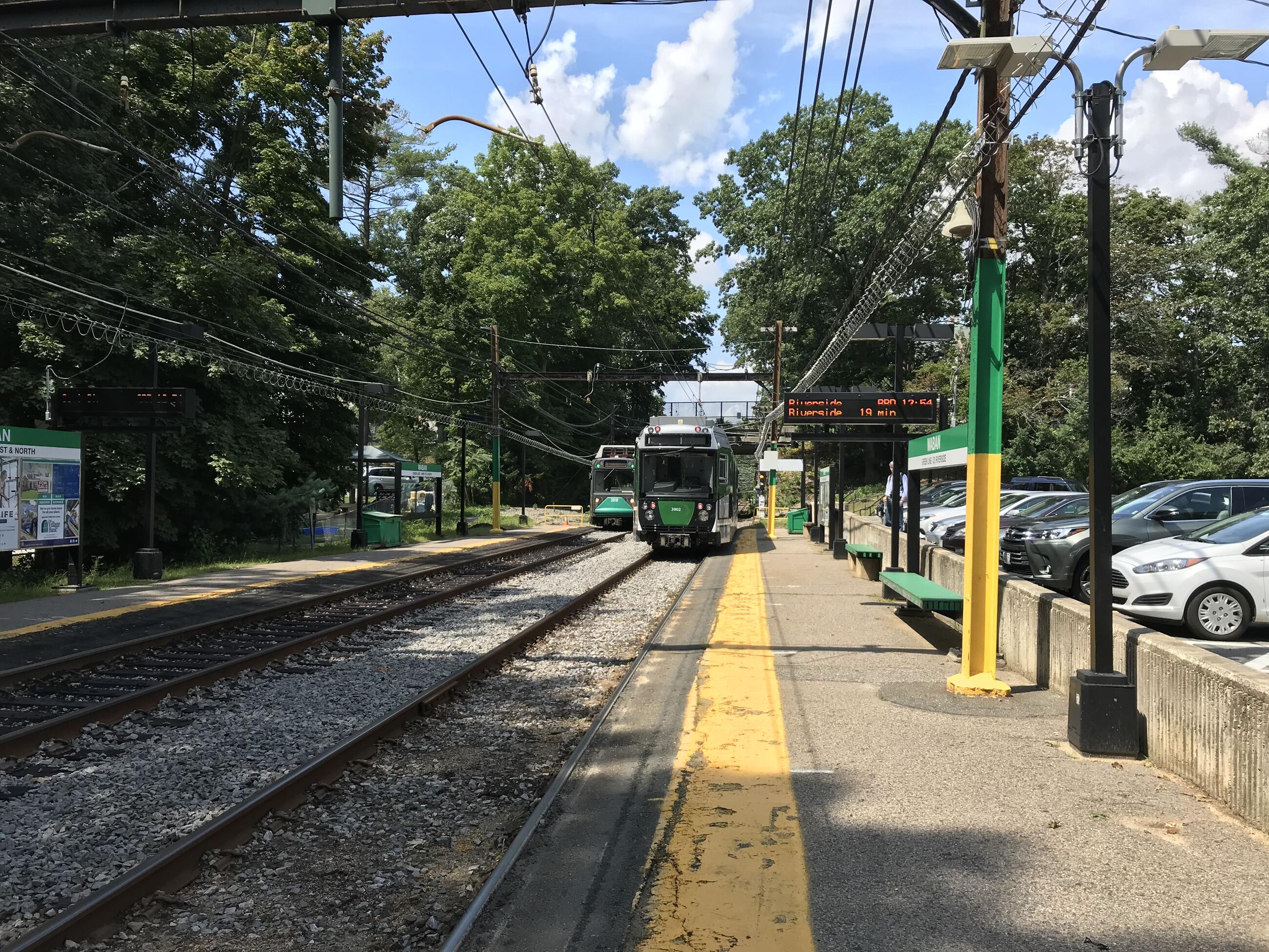 A Green Line train at the Waban station. The entire platform and tracks are visible
