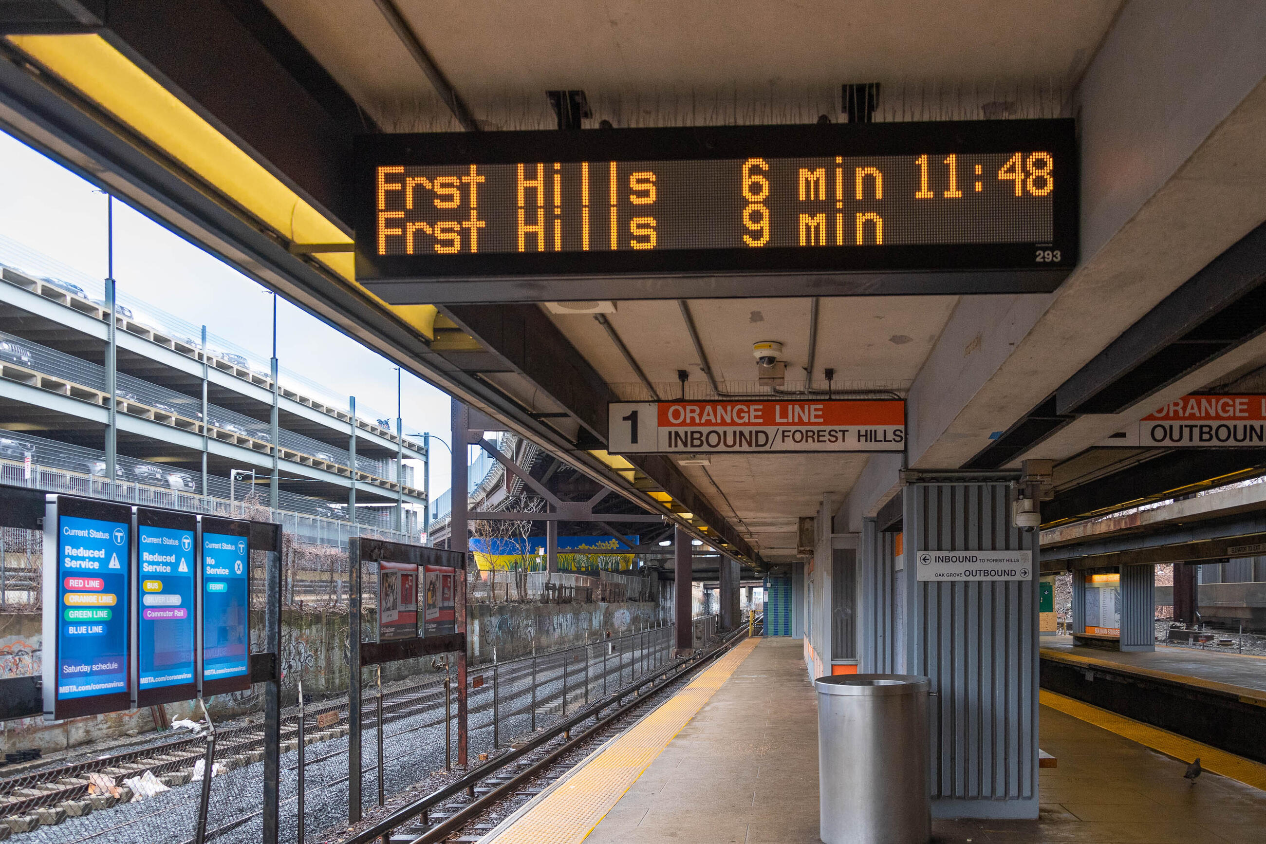 A photo of a countdown clock at Forest Hills station on the Orange Line. It says 
