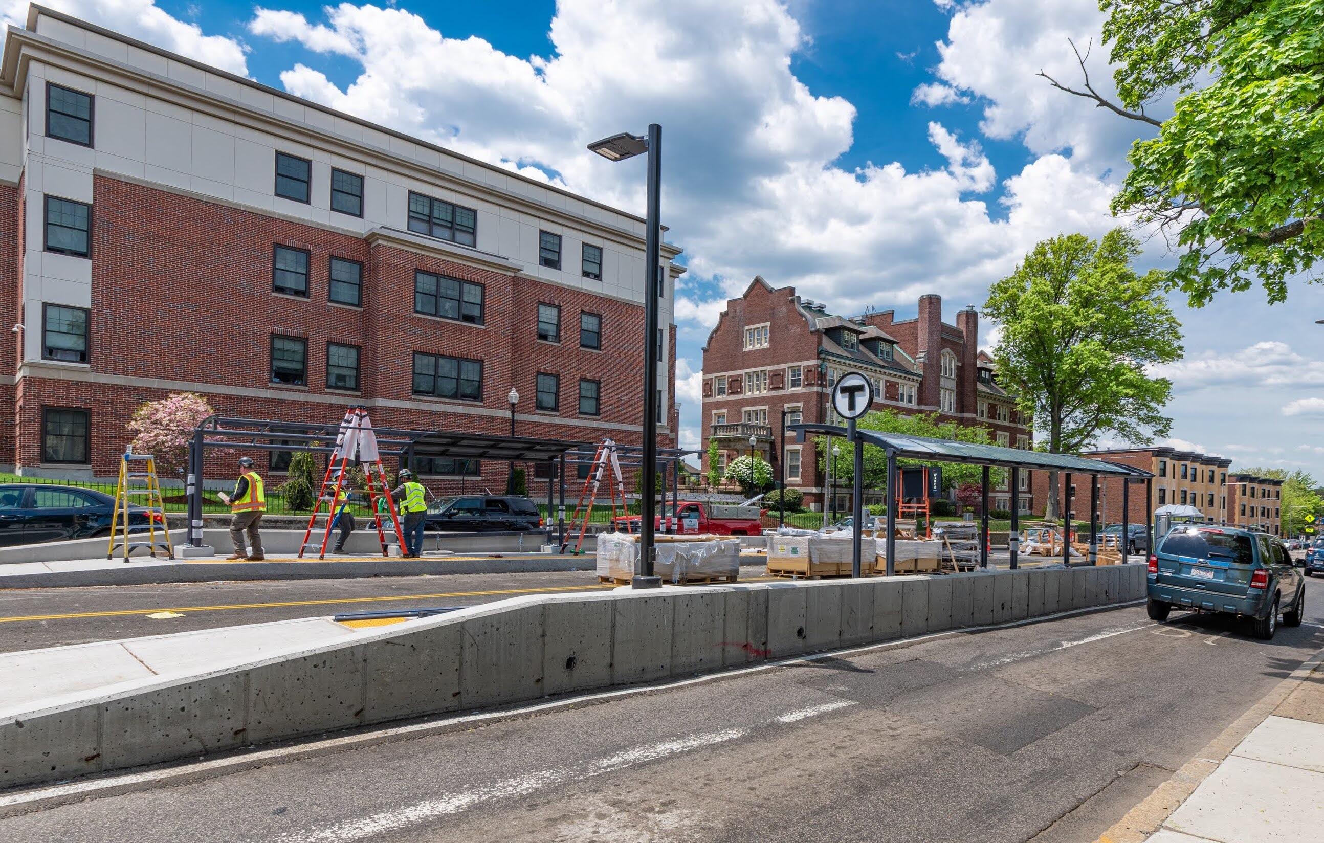 A newly completed canopy shelter on the Columbus Avenue center bus lane. Another canopy is under construction across the road.