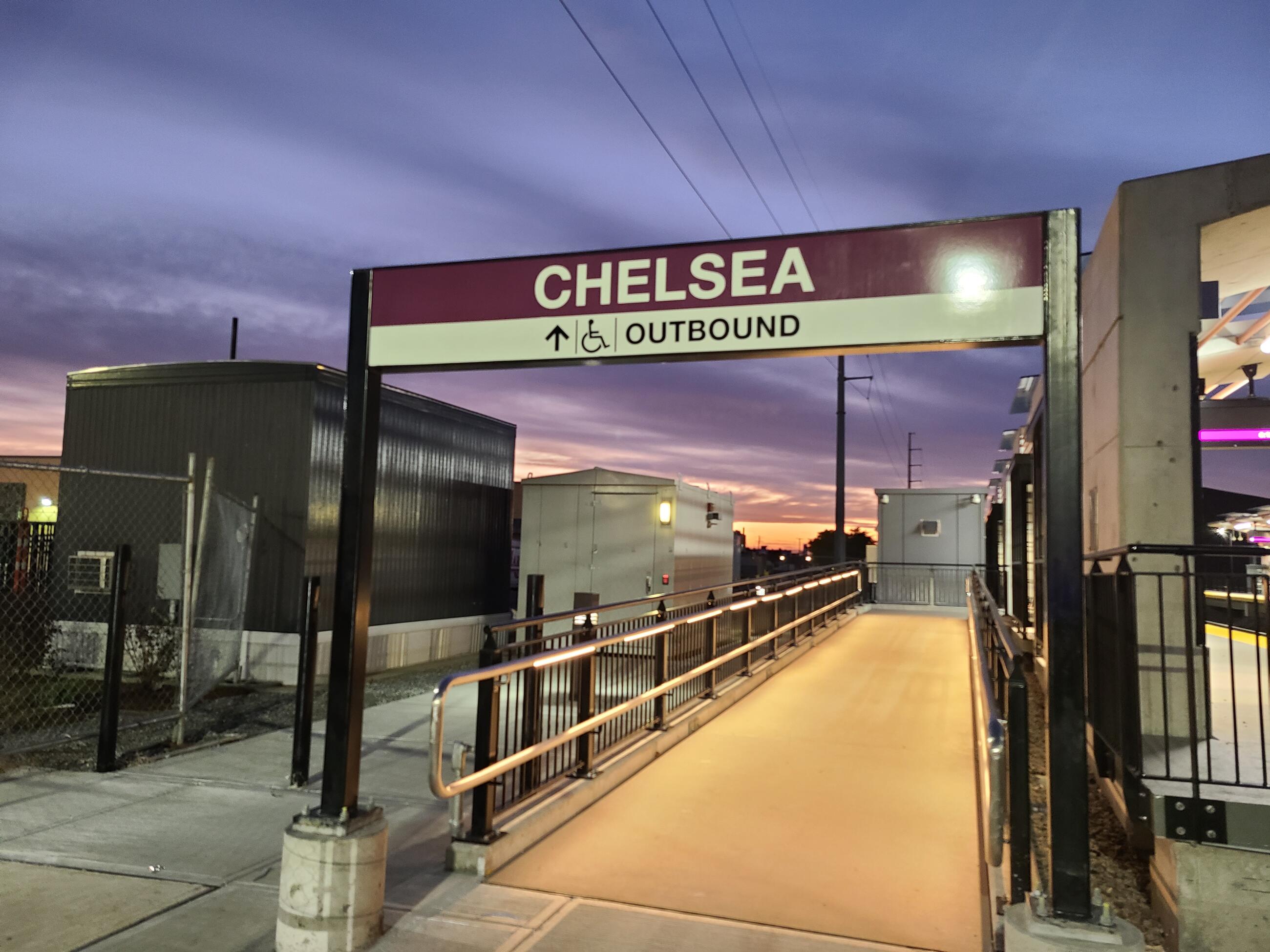 The new station sign has been installed over the ramp connecting the Silver Line to the Chelsea Commuter Rail station's outbound platform (October 2021)