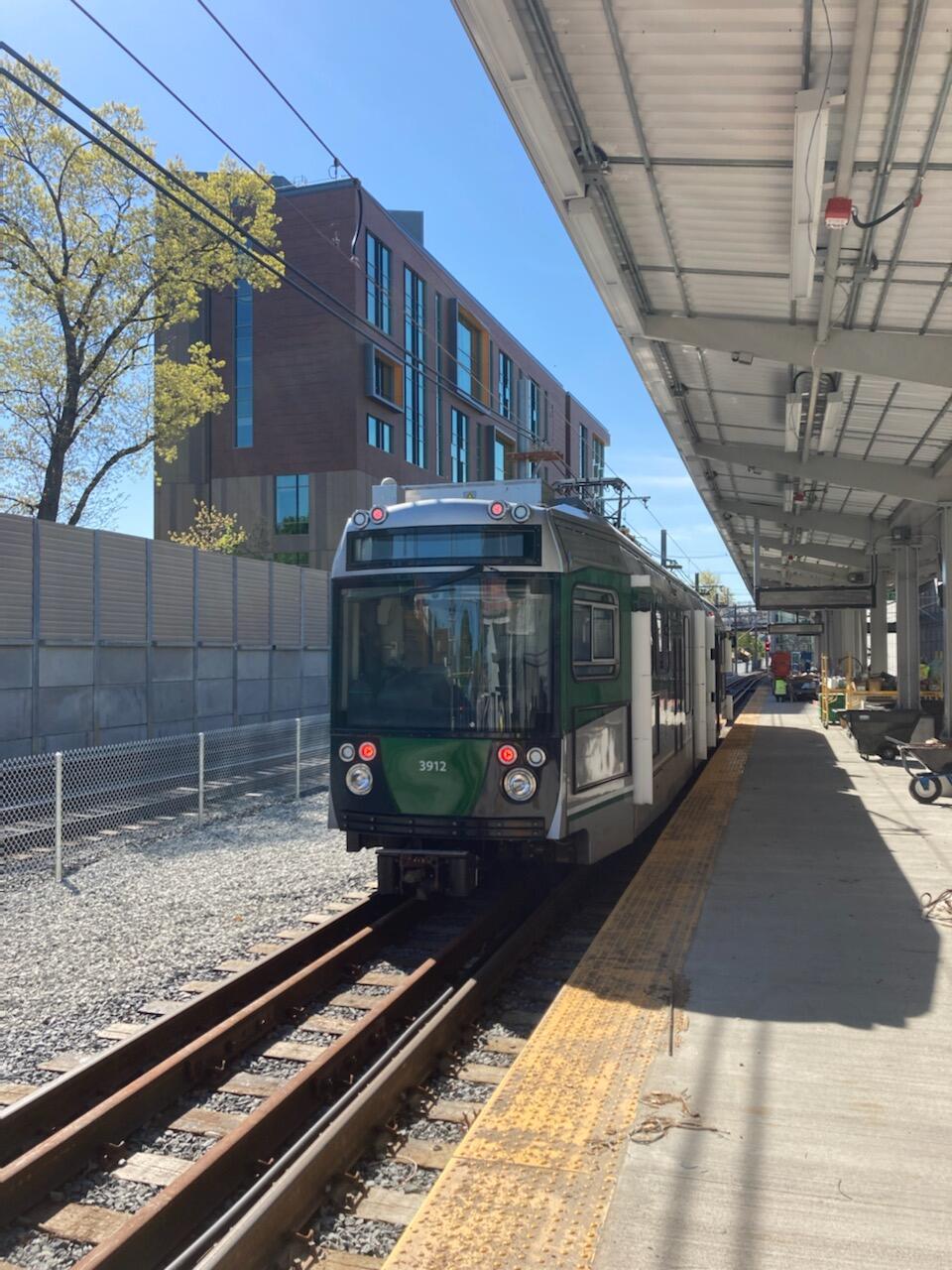 A Green Line test train arrives at Medford Tufts station
