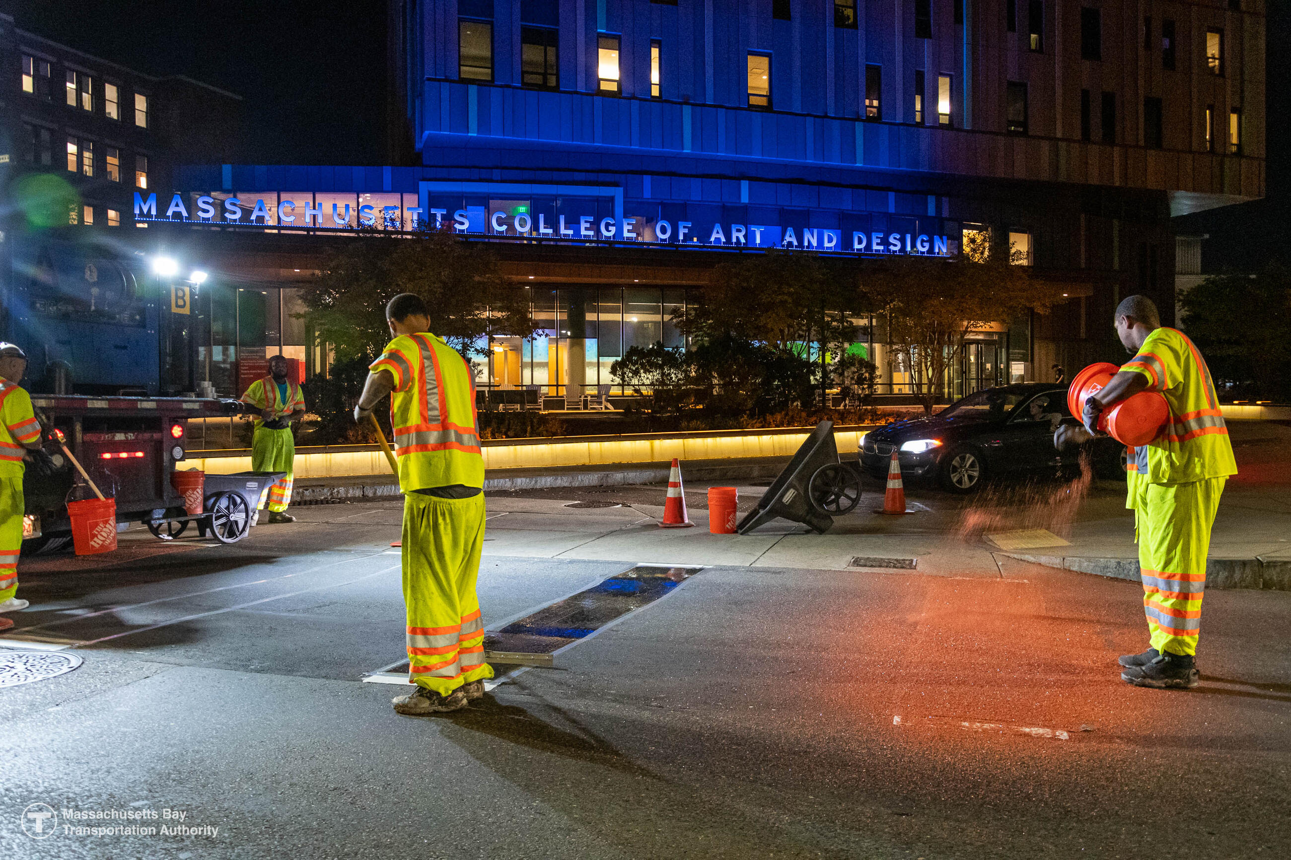Crew member installs roadway markings for initial phase of Huntington Avenue shared bus-bike lane near the intersection of Vancouver Street in October 2022. Crews will be completing the bus-bike lane striping this fall. Photo credit: MBTA
