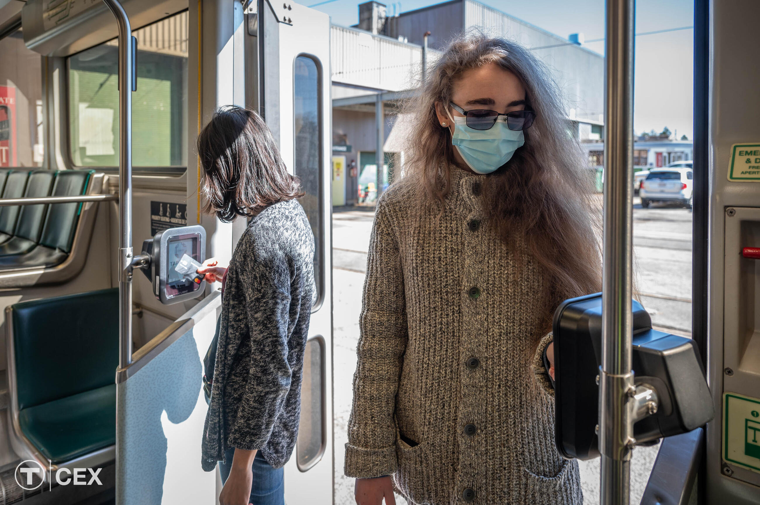 Riders using fare readers on Green Line