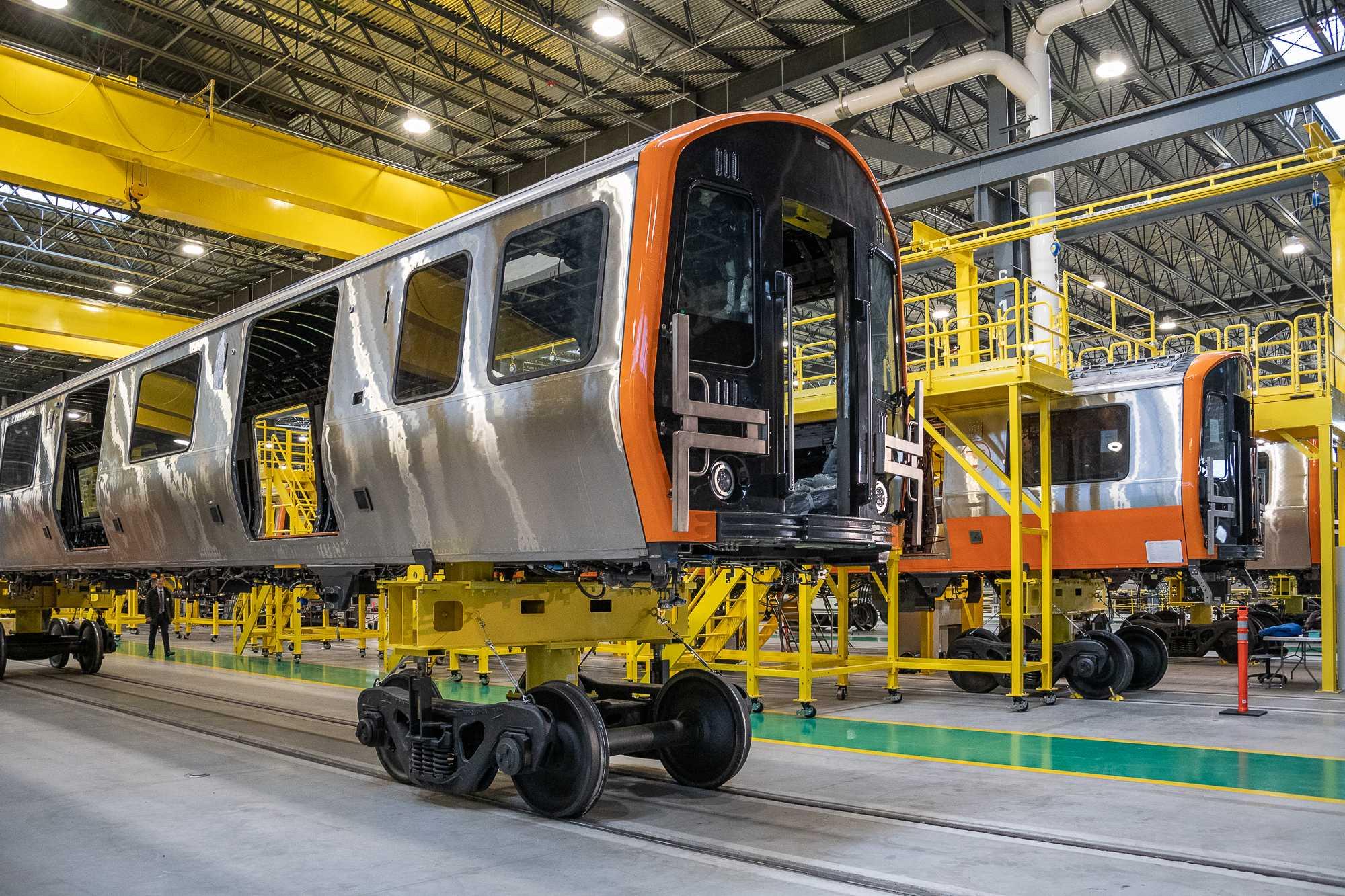 New Orange Line Car on a lift, separated from its wheels