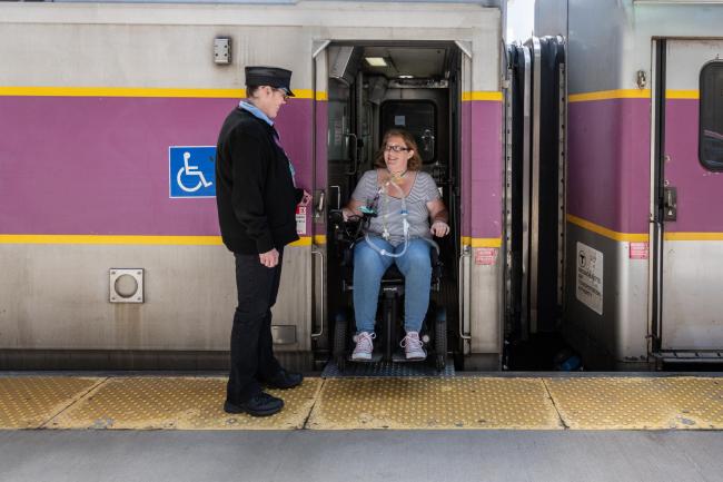 customer with wmd exiting commuter rail at level boarding platform