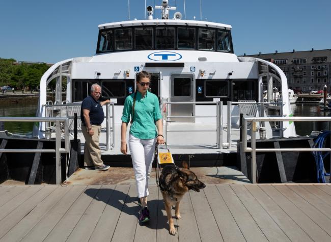 customer exiting mbta ferry with guide dog