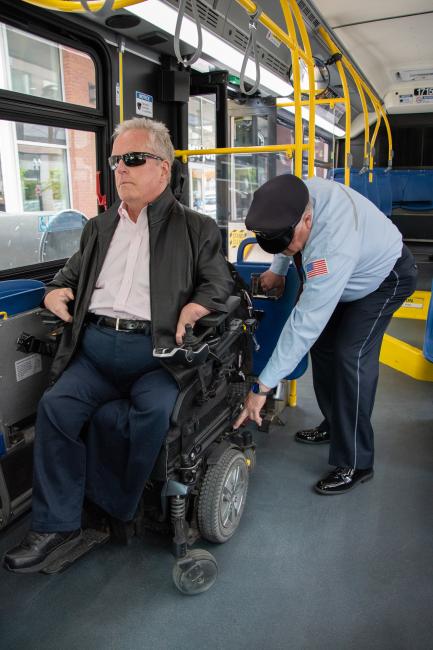 bus operator securing wheeled mobility device
