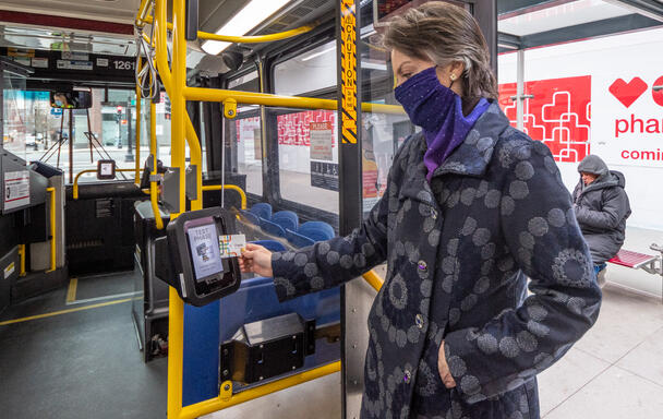 A field demo particpant uses one of the new CharlieCard reader prototypes installed on bus routes 28 and 39